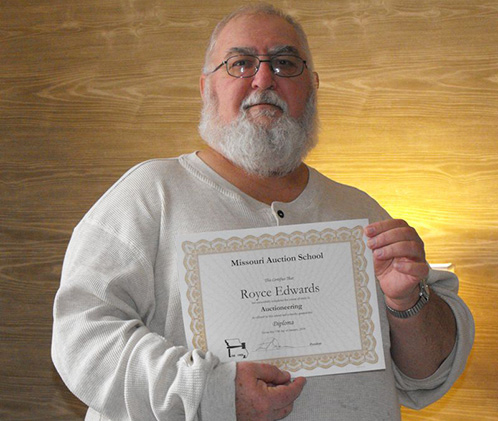 Royce Edwards holding Missouri Auction School diploma