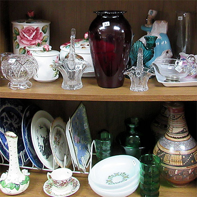 Assorted glass & ceramic items on shelves
